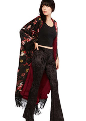 Woman wearing a black floral kimono with red accents on a white background
