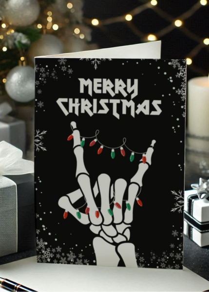 Christmas card with skeleton hand and lights design, surrounded by festive decorations.