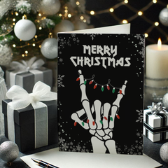 Christmas card with skeleton hand and lights design, surrounded by festive decorations.