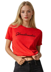 Woman wearing a red 'Heartbreaker' t-shirt on a white background
