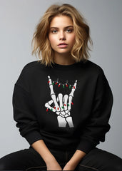 Person wearing a black sweatshirt with a skeleton hand design on a gray background