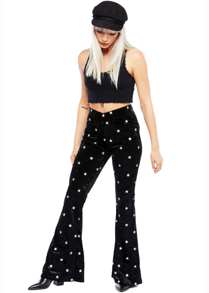 Black velvet star print flare trousers